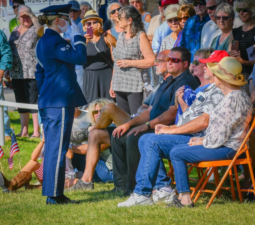 Senior Airman Brittany Watts, member of the Nellis Honor Guard, 99th Air Base Wing, Nellis Air Force Base, Nev. salutes the flag presented to Mrs. Vicki Waggoner in honor of her late husband, retired U.S. Air Force Col. Robert F. Waggoner at a ceremony in Bishop California. (Air Force photo by Danny Bazzell)