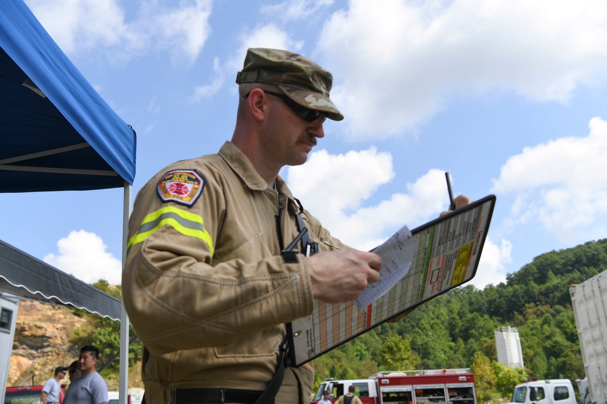 Technical Sgt. Robert Laidlow, 167th Fire and Emergency Services, monitors and keeps account of the firefighters assigned to his team during collapsed structure training as part of Exercise Vigilant Guard 2021 Aug. 27, 2021.