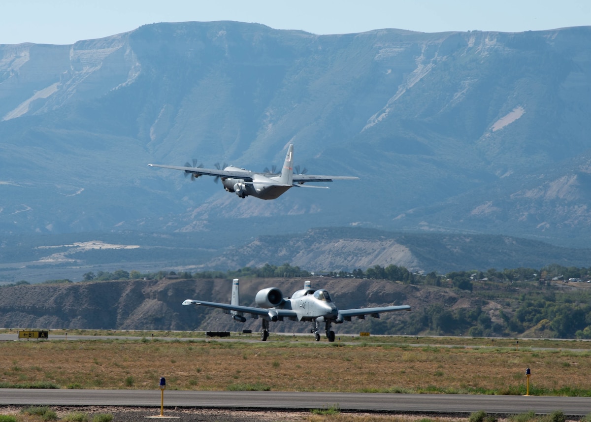 A C-130J Super Hercules flown by the 815th Airlift Squadron, Keesler Air Force Base, Mississippi, departs while an A-10 Thunderbolt II aircraft flown by the 354th Fighter Squadron, Davis-Monthan Air Force Base, Arizona, arrives at Rifle Garfiield County Airport, Colorado, Sept. 15, 2021. Active-duty Air Force, Air National Guard and Reserve Citizen Airmen gathered at the airfield to take part in the 22nd Air Force’s flagship exercise Rally in the Rockies Sept. 12-17, 2021. The exercise is designed to develop Airmen for combat operations by challenging them with realistic scenarios that support a full spectrum of operations during military actions, operations or hostile environments.