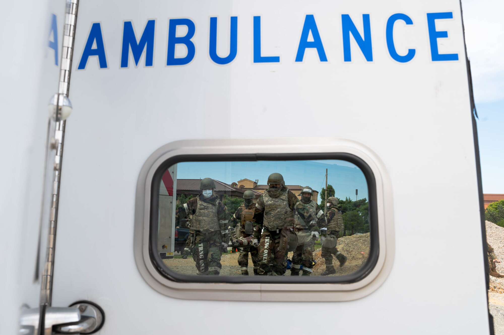 Airmen from the 51st Medical Group transport a patient with mock injuries to an ambulance during a mass casualty training event
