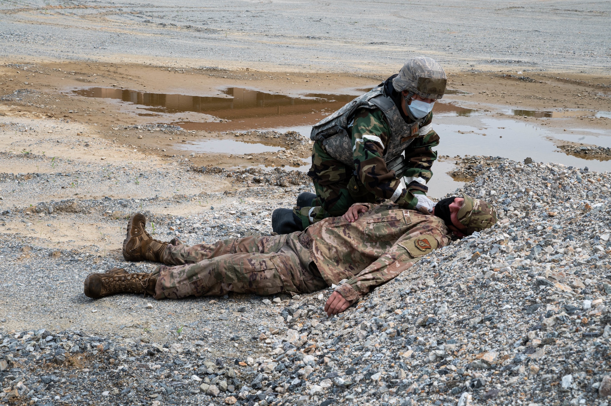 Capt. Danielle Miltenberg from the 51st Medical Group locates a mock deceased member during a mass casualty training event
