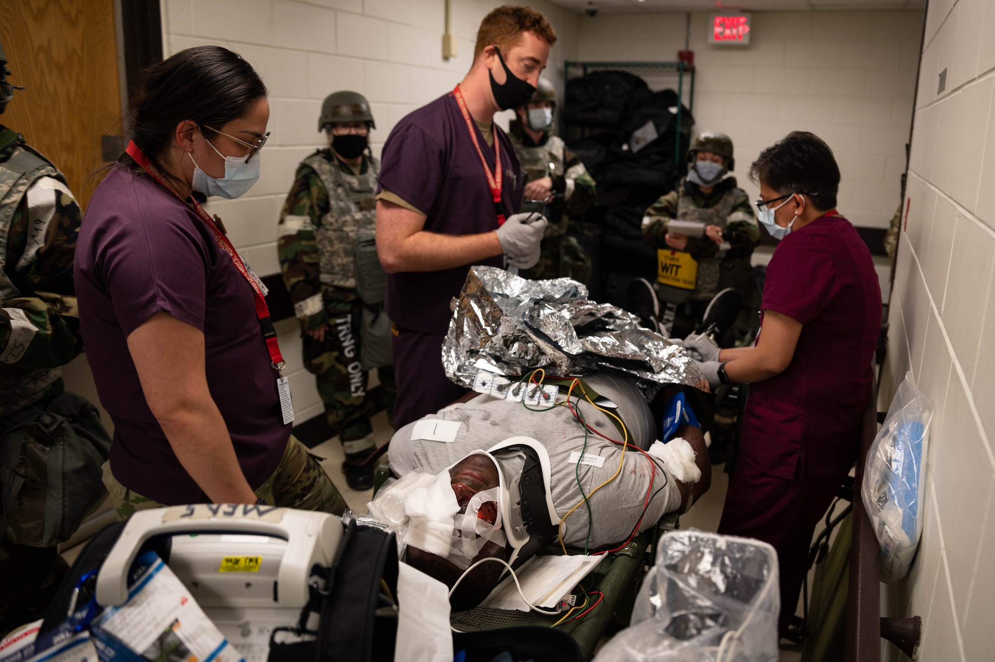 Members of the 51st Medical Group treat a patient with multiple mock injuries during a mass casualty training event