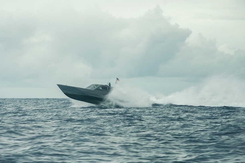A combatant craft medium (CCM) assigned to a West-coast based naval special warfare unit maneuvers in the waters off the coast of Guam.
