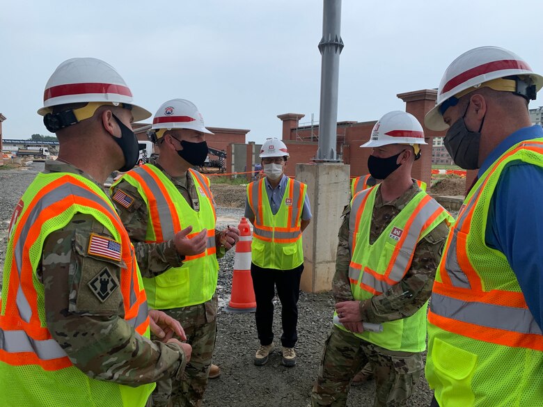 Brig. Gen. Kirk Gibbs, U.S. Army Corps of Engineers Pacific Ocean Division commander (top left), and Command Sgt. Maj. Douglas Galick, POD command sergeant major (top right), visit FED construction site, FH100 Army Family Housing Towers, to view ongoing construction and to speak with the project delivery team at USAG Humphreys, Aug. 25.