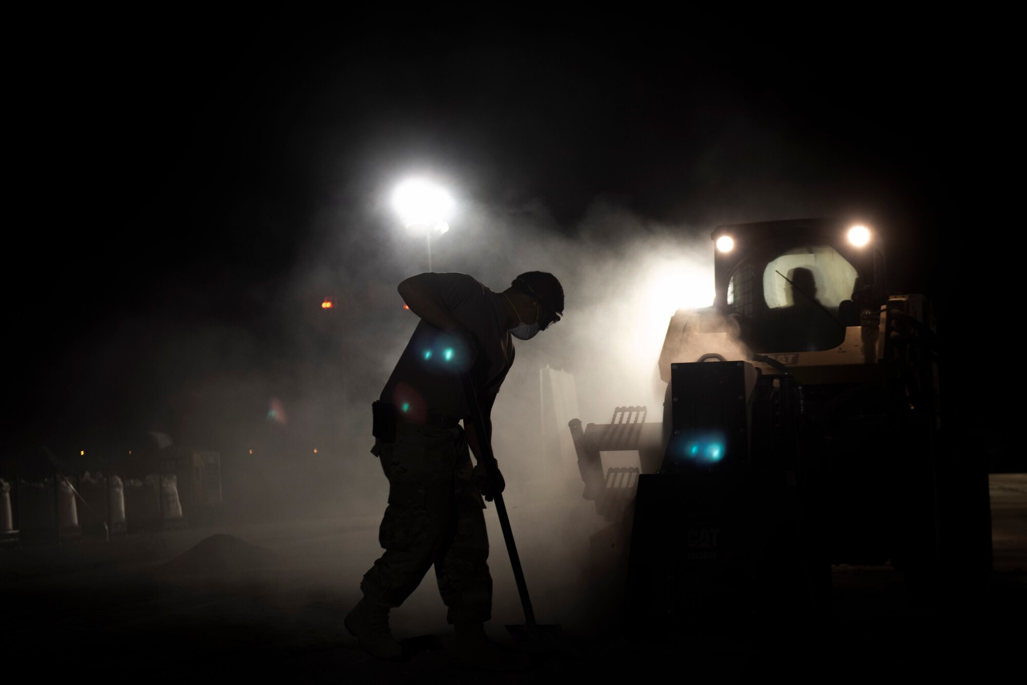 A photo of an Airman shoveling debris