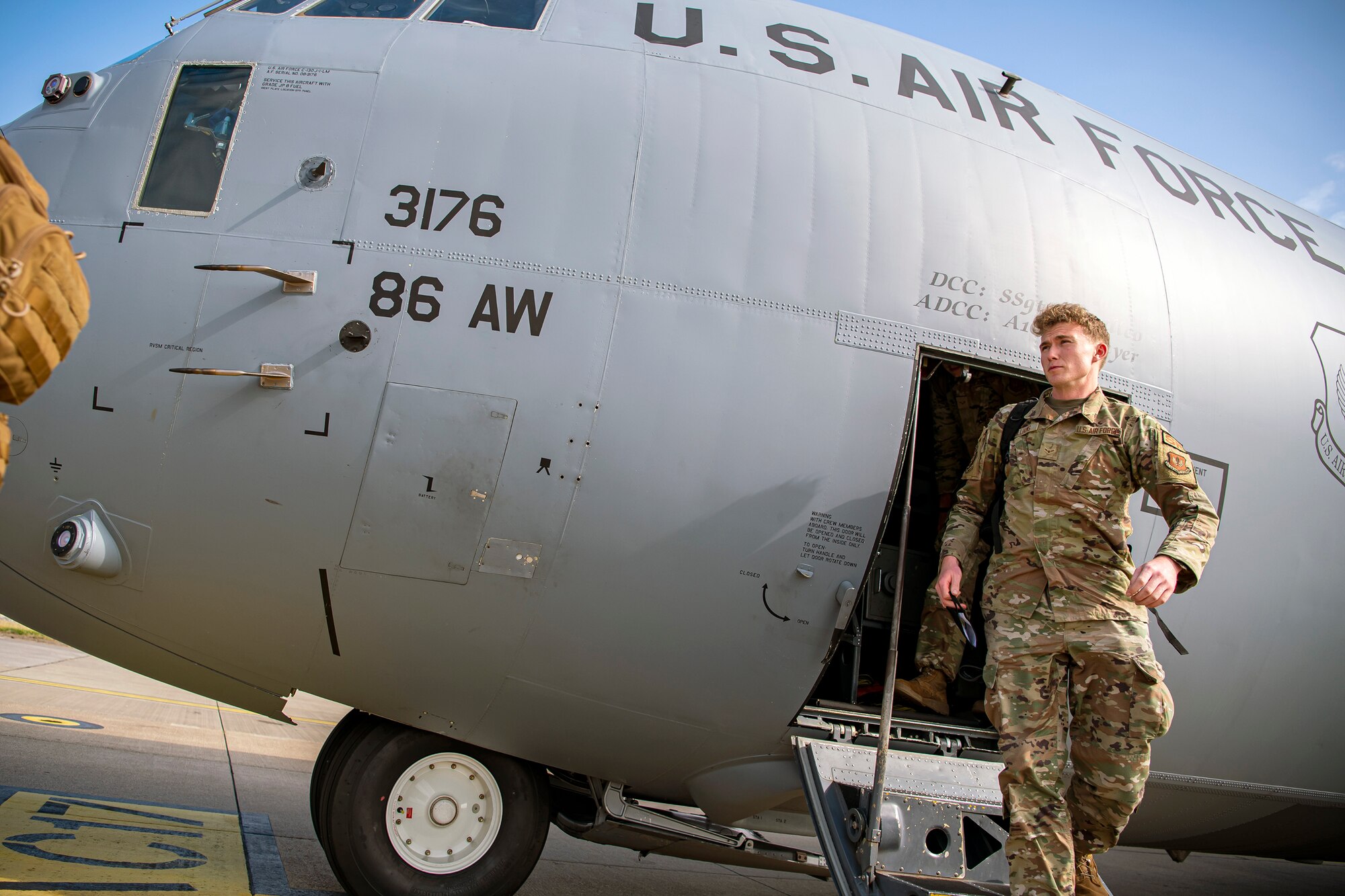 An Airman disembarks from a HC-130J Combat King II at RAF Mildenhall, England, Sept. 16, 2021. Defenders from the 501st Combat Support Wing, 48th Fighter Wing and 100th Air Refueling Wing returned from Ramstein Air Force Base, Germany, after providing support for Operation Allies Refuge. (U.S. Air Force photo by Senior Airman Eugene Oliver)