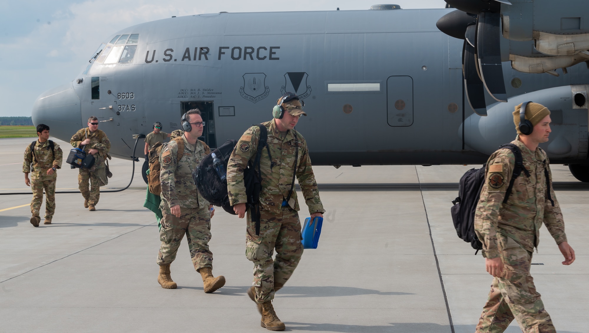 Airmen depart aircraft.