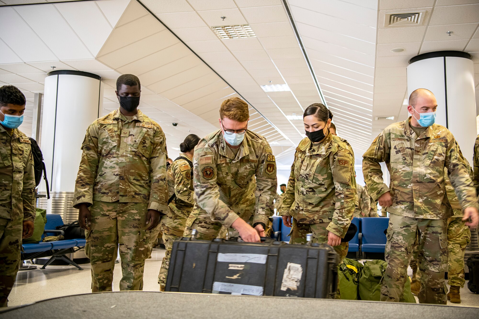 Airmen from the 501st Combat Support Wing, 48th Fighter Wing and 100th Air Refueling Wing, grab bags in the passenger terminal at RAF Mildenhall, England, Sept. 16, 2021. Defenders from the 501st CSW, 48th FW and 100th ARW returned from Ramstein Air Force Base, Germany, after providing support for Operation Allies Refuge. (U.S. Air Force photo by Senior Airman Eugene Oliver)