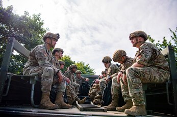 Security Forces Airmen wait to be transported from the passenger terminal at RAF Mildenhall, England, Sept. 16, 2021. Defenders from the 501st Combat Support Wing, 48th Fighter Wing and 100th Air Refueling Wing returned from Ramstein Air Force Base, Germany, after providing support for Operation Allies Refuge. (U.S. Air Force photo by Senior Airman Eugene Oliver)