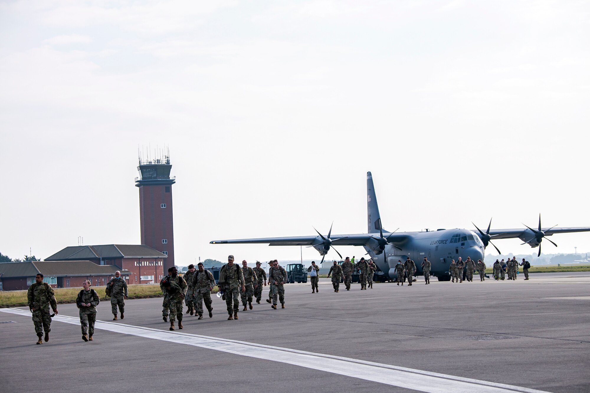 Security Forces Airmen from the 501st Combat Support Wing, 48th Fighter Wing and 100th Air Refueling Wing, walk on the flightline at RAF Mildenhall, England, Sept. 16, 2021. The Defenders returned from Ramstein Air Force Base, Germany, after providing support for Operation Allies Refuge.  (U.S. Air Force photo by Senior Airman Eugene Oliver)