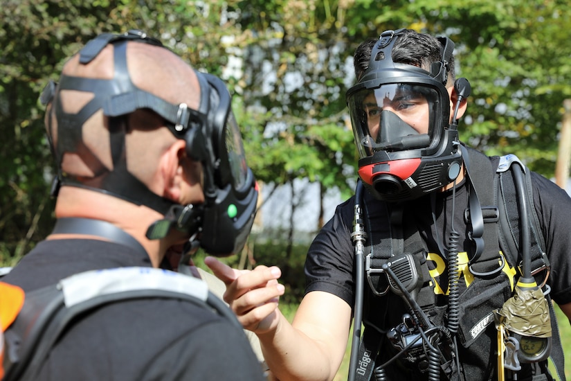 U.S. Army Reserve Staff Sgt. Ruberth Valencia, right, a survey team chief with the 773rd Civil Support Team, 7th Mission Support Command, based out of Kaiserslautern, Germany, tests communication capabilities with 773rd operations noncommissioned officer, Sgt. 1st Class Juan Morales, before the two Soldiers suit up in chemical, biological, radiological, nuclear protective gear during exercise Toxic Valley 2021 in Zemianske Kostoľany, Slovakia, Sept. 14, 2021. Toxic Valley is a Slovac Armed Forces-led live agent CBRN exercise that provides training for multinational military CBRN units stationed throughout Europe. (U.S. Army Reserve photo by Master Sgt. Joy Dulen, 7th Mission Support Command)