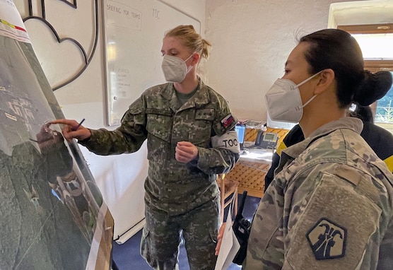 U.S. Army Reserve Capt. Shawna So, right, a survey team leader with the 773rd Civil Support Team, 7th Mission Support Command, based out of Kaiserslautern, Germany, receives an exercise scenario mission brief from Slovac Armed Forces Capt. Lucia Machajdikova during exercise Toxic Valley 2021 in Zemianske Kostoľany, Slovakia, Sept. 14, 2021. Toxic Valley is a Slovac Armed Forces-led live agent chemical, biological, radiological, nuclear exercise that provides training for multinational military CBRN units stationed throughout Europe. (U.S. Army Reserve photo by Master Sgt. Joy Dulen, 7th Mission Support Command)