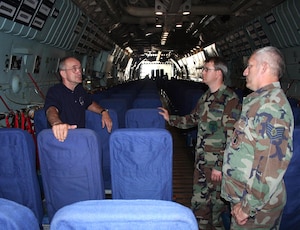 Three people talking on an aircraft