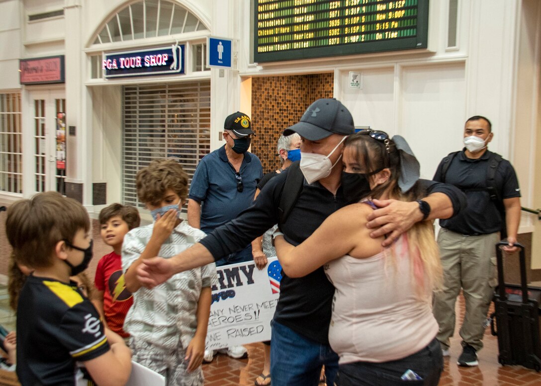 Sgt. 1st Class Carlos Colon, Jr, is surprised by friends and family, Sept. 15, at the Savannah Hilton Head International Airport following a 6-month deployment with the 542nd Engineer Detachment, Forward Engineer Support Team – Advance. (USACE Photo by Nathan Wilkes)