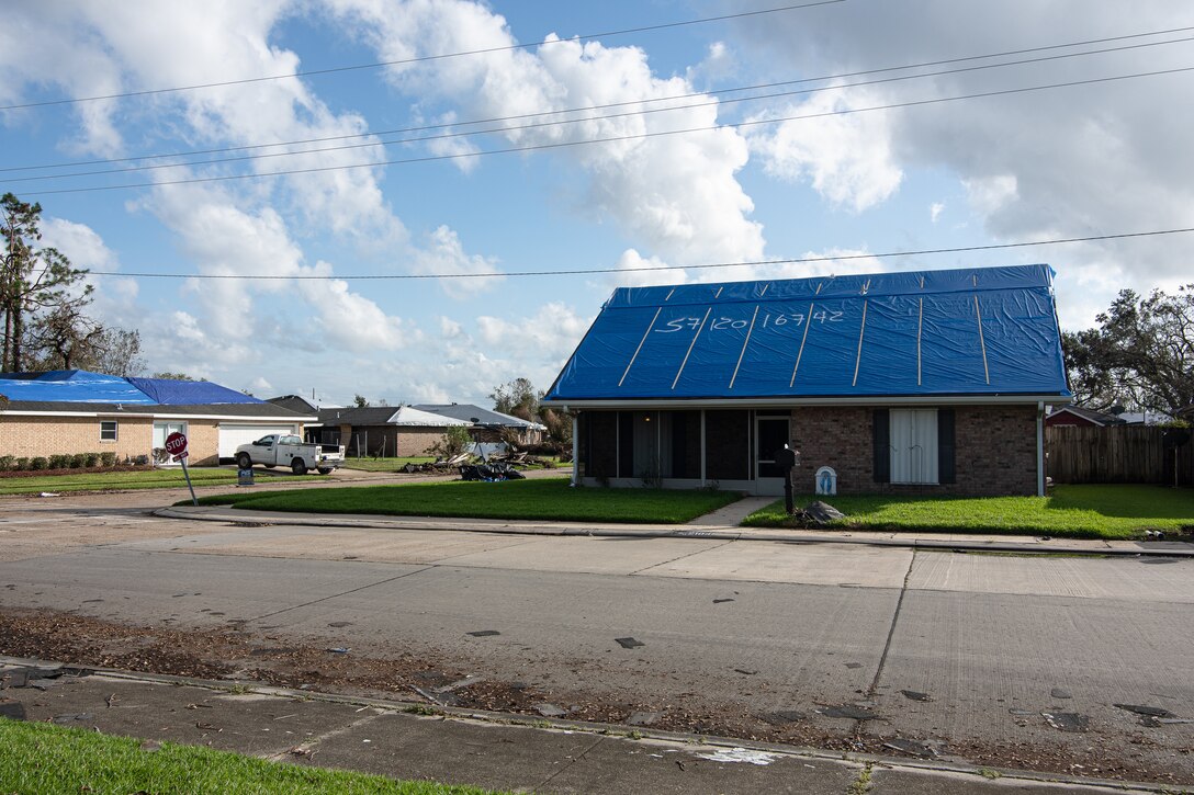 James Muilenburg, a US Army Corps of Engineers, Omaha District employee serving as a national local government liaison, looks at a recently installed blue roof in Houma Louisiana.