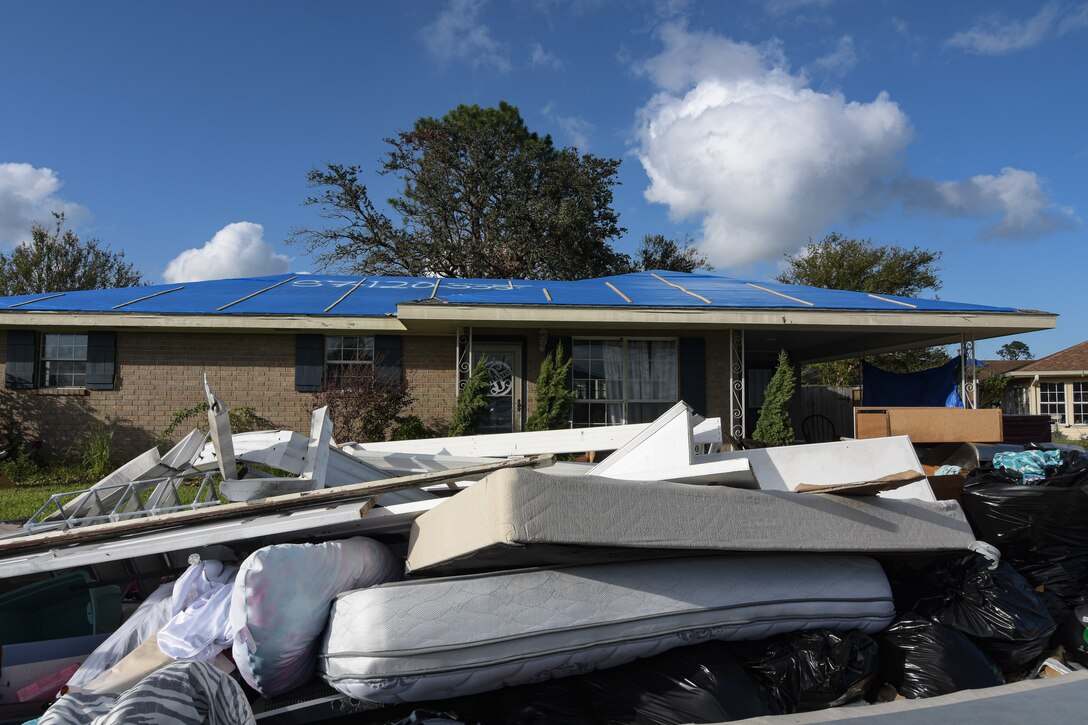 ames Muilenburg, a US Army Corps of Engineers, Omaha District employee serving as a national local government liaison, looks at a recently installed blue roof in Houma Louisiana. T