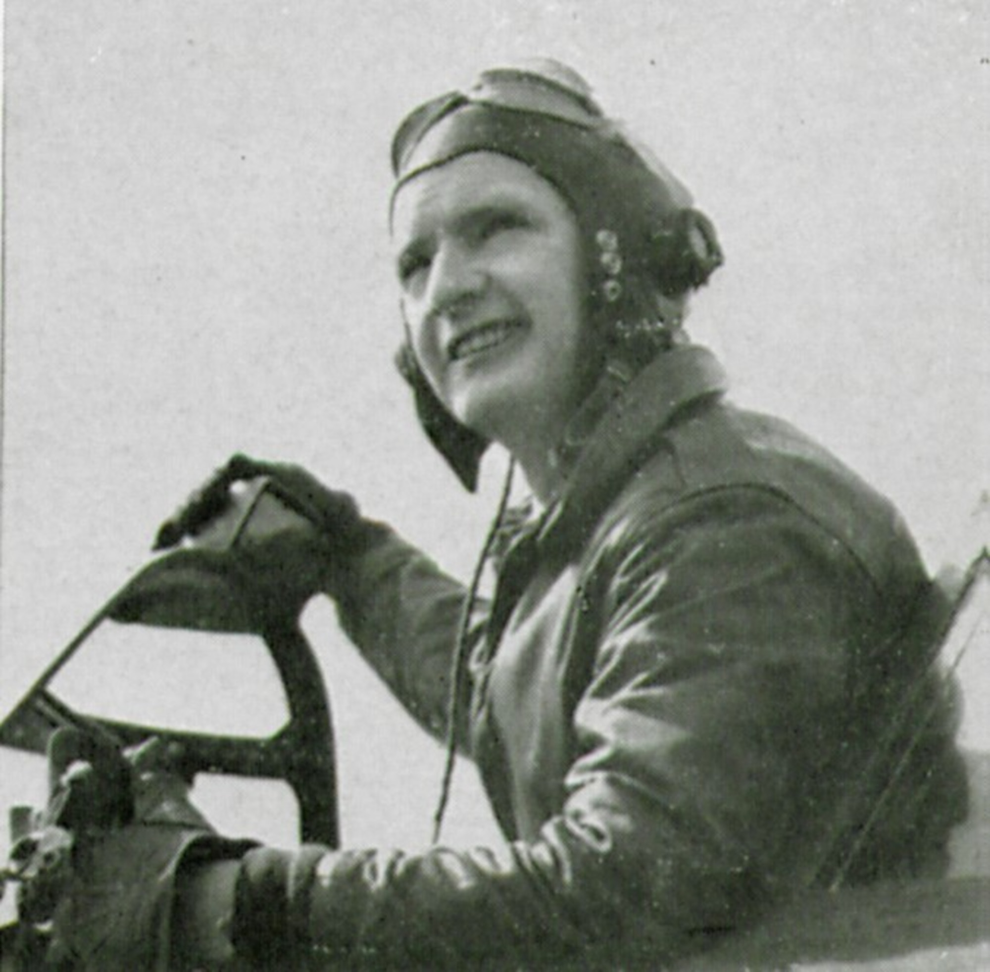 Flight Officer (F/O) William (NMI) Gorman, T-223063, poses for a picture in the cockpit of a Republic P-47D Thunderbolt fighter. Note his right hand rests atop the rear-view mirror on the windscreen of this “Razorback” version of the P-47.  (The Story of the 371st Fighter Group in the ETO)