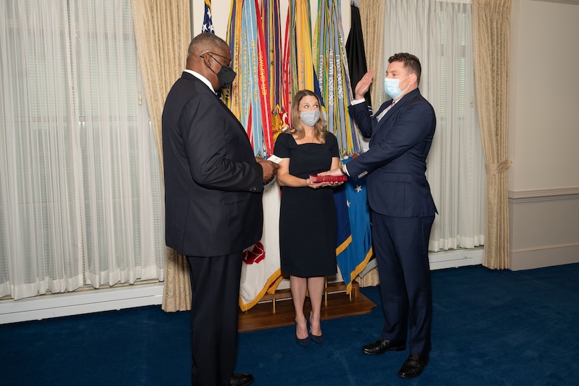 Secretary of Defense Lloyd J. Austin III swears in Christopher Maier.