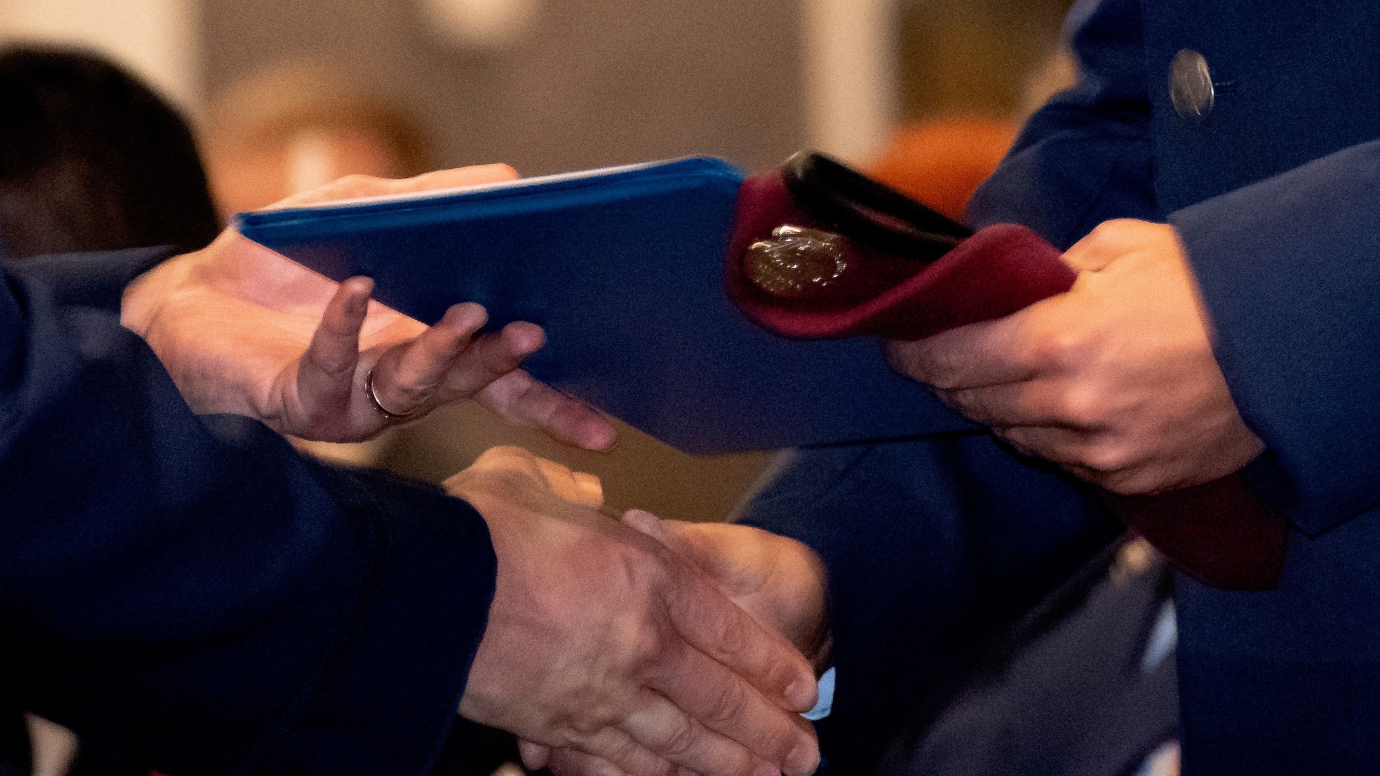A graduating pararescueman receives his maroon beret.