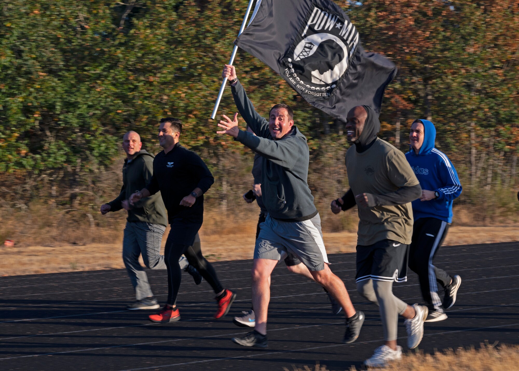 U.S. Air Force Maj. Zachary Magnin, 62nd Aircraft Maintenance Squadron commander, bears the POW/MIA flag as he and other 62nd AMXS leadership participate in the 24-hour POW/MIA Remembrance Run at Joint Base Lewis-McChord, Washington, Sept. 16, 2021. The official U.S. POW/MIA flag was created through the efforts of family members of POW/MIA Americans to display a suitable symbol that made the public aware of their loved ones who were being held prisoner or declared missing during the Vietnam War. (U.S. Air Force photo by Senior Airman Zoe Thacker)