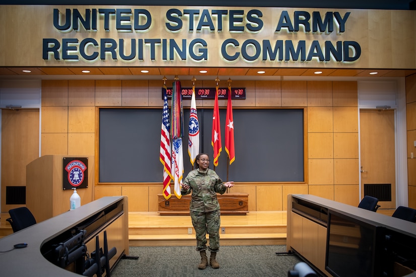 woman in uniform standing in the middle of a room.