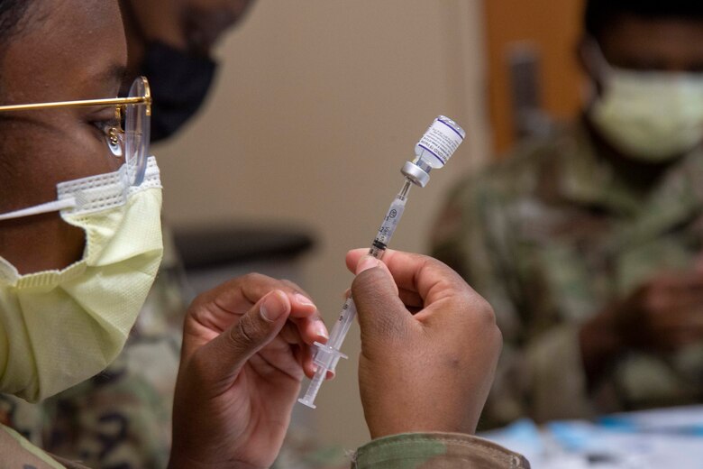 An Airman from the 6th Medical Group (MDG) prepares a COVID-19 vaccine for distribution at MacDill Air Force Base, Florida, Sept. 17, 2021.