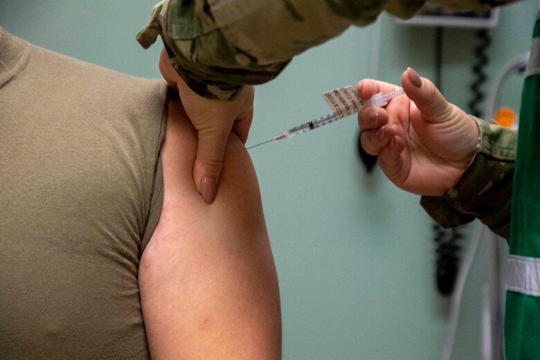 An Airman from the 6th Medical Group (MDG) provides a patient with the COVID-19 vaccine at MacDill Air Force Base, Florida, Sept. 17, 2021.