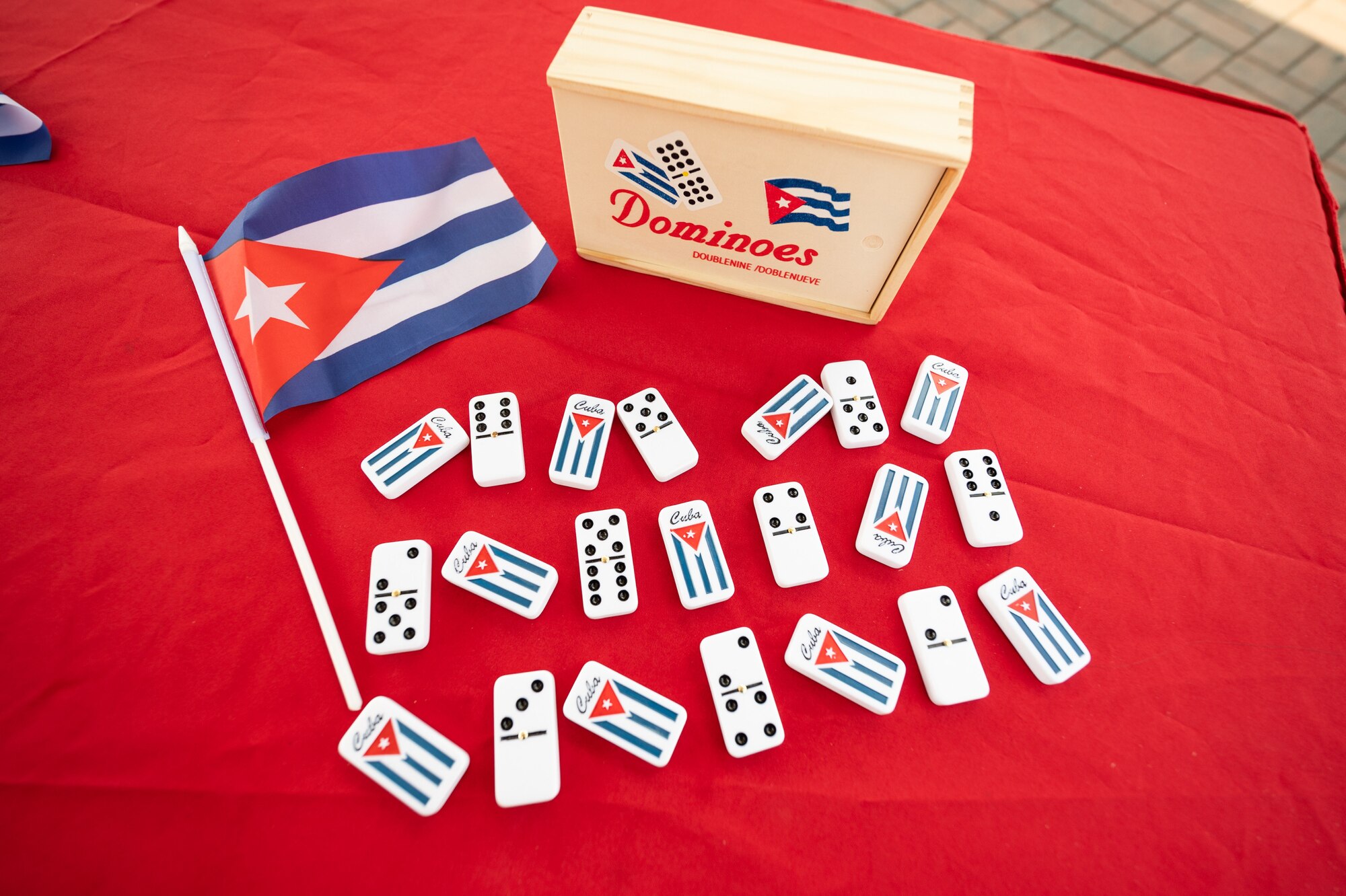 A dominoes set with the Cuban flag is displayed at the Hispanic Heritage Month Block Party on Dover Air Force Base, Delaware, Sept. 15, 2021. Dominoes is a popular game throughout many Latin American countries. National Hispanic Heritage Month is observed from Sept.r 15 to Oct. 15 in recognition and celebration of Latin American history and culture. (U.S. Air Force photo by Mauricio Campino)