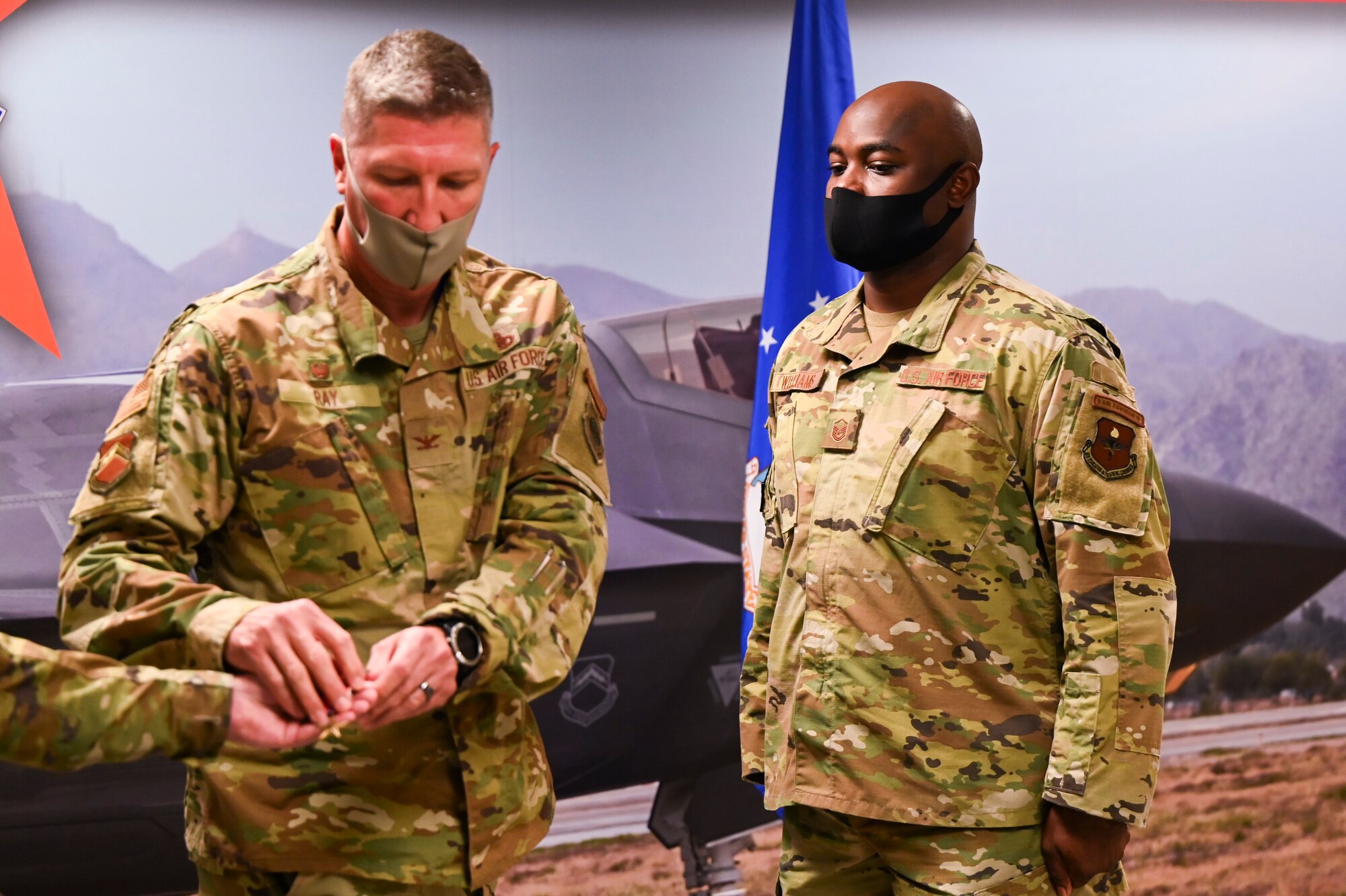 U.S. Air Force Col. William Ray, 56th Maintenance Group commander, awards the Bronze Star Medal to U.S. Air Force Master Sgt. Thomas Williams, 62nd Aircraft Maintenance Unit weapons loading non-commissioned officer in charge, for meritorious achievement Sept. 1, 2021, at Luke Air Force Base, Arizona.