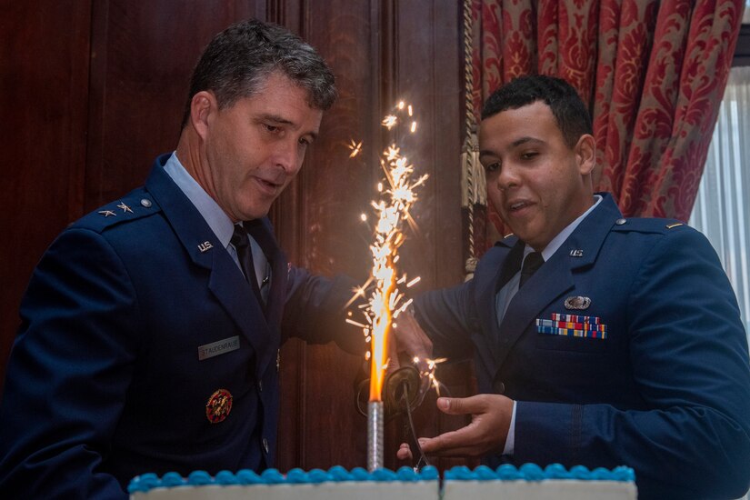 U.S. Air Force Maj. Gen. Randolph J. Staudenraus, director of strategy, policy, plans and international Affairs (J-5), National Guard Bureau, assists as youngest member in attendance, Air National Guard 2nd Lt. Brendan Coble, a budget officer with the 111th Attack Wing headquartered at Biddle Air National Guard Base in Horsham, Pennsylvania, in cutting the cake during a 74th Air Force birthday celebration hosted by and held at the Union League of Philadelphia, Sept. 15, 2021. This year, the Air Force celebrates more than seven decades as a military component.