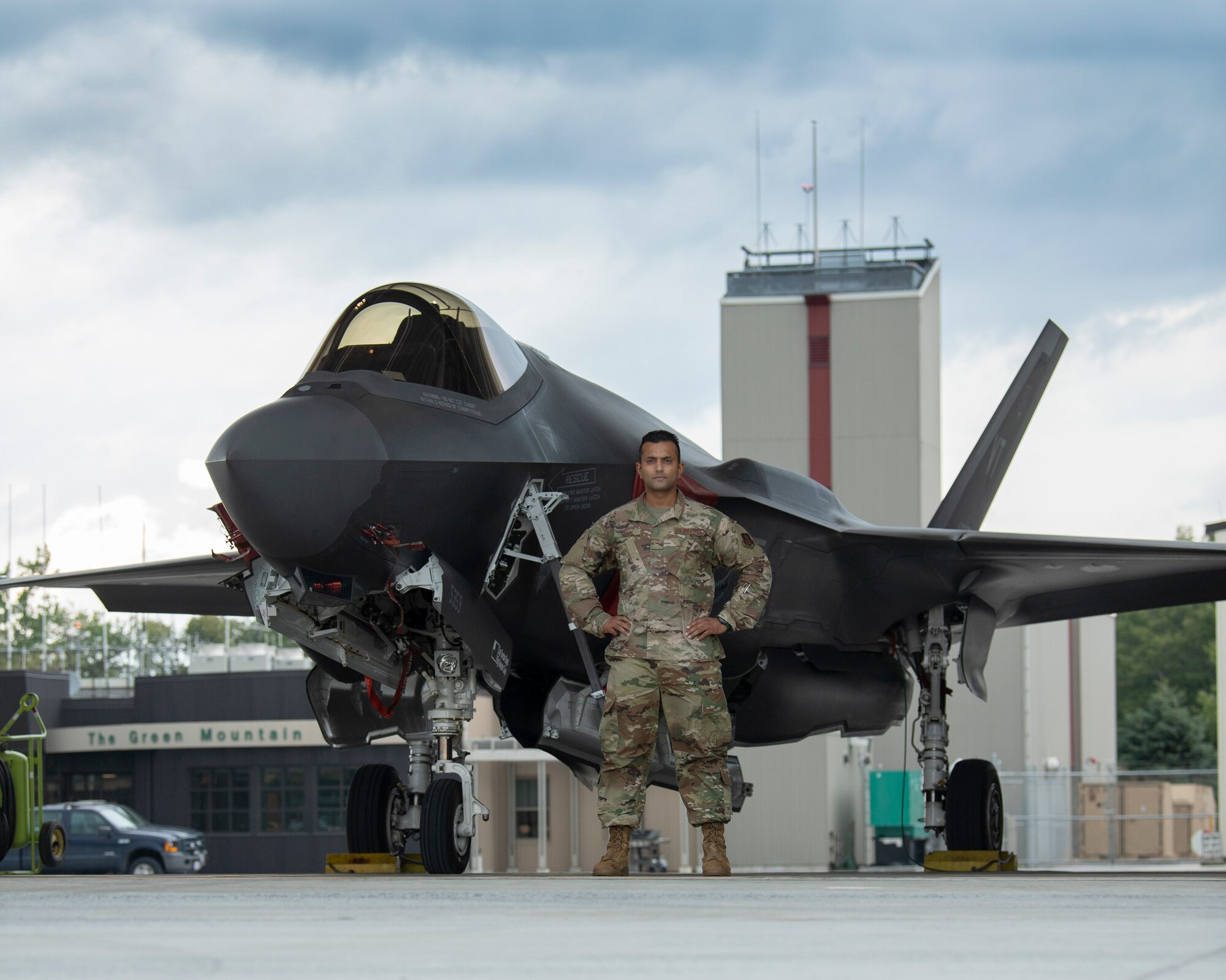 Picture of Airmen 1st Class Komalpreet Saini standing for a picture in front of an F-35A Lightning II aircraft assigned to the Vermont Air National Guard.