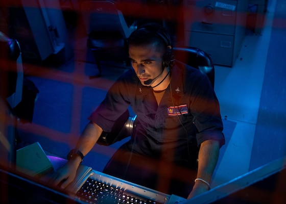 Fire Controlman (Aegis) 3rd Class Thomas Tecchio, from Norwood, N.J., stands the spy radar system control watch aboard Arleigh Burke-class guided-missile destroyer USS Barry (DDG 52) during routine operations