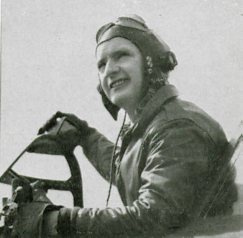 Flight Officer (F/O) William (NMI) Gorman, T-223063, poses for a picture in the cockpit of a Republic P-47D Thunderbolt fighter. Note his right hand rests atop the rear-view mirror on the windscreen of this 