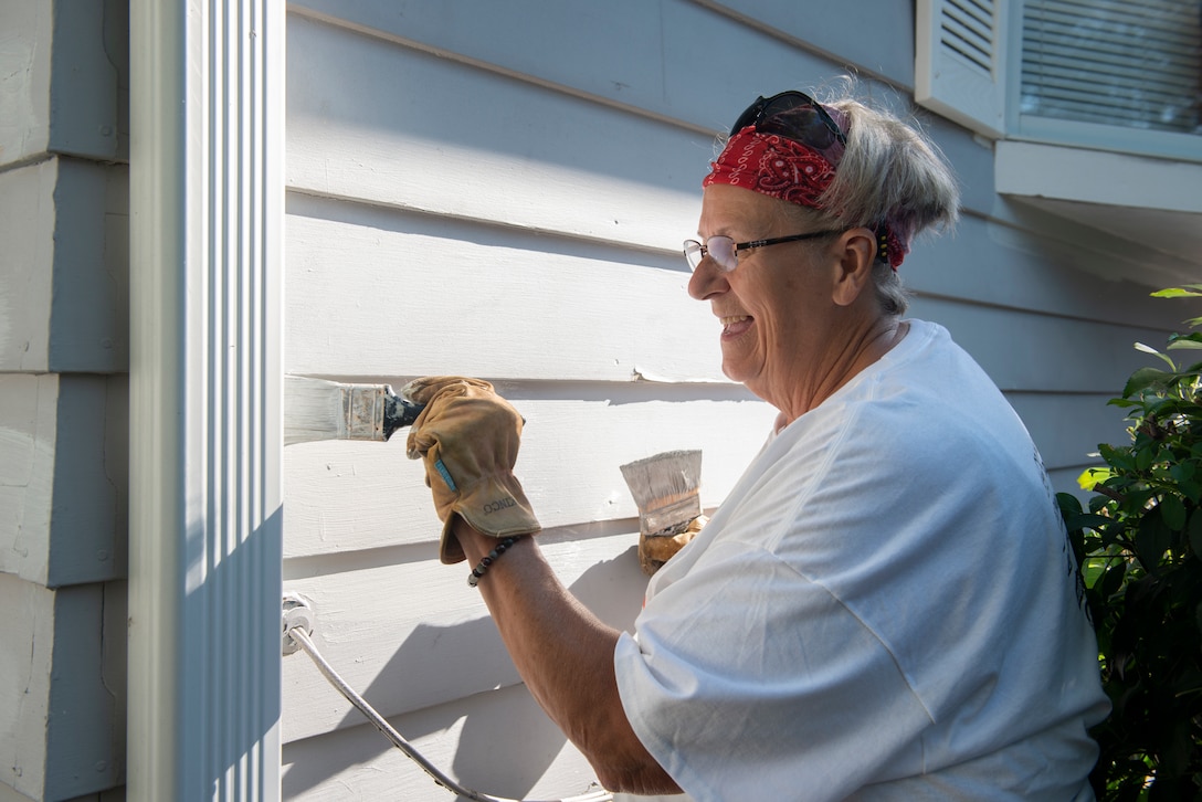 Joyce Ridout, long-time volunteer,paints the side of the house during the 2021 Paint-A-Thon, Aug. 21, 2021,