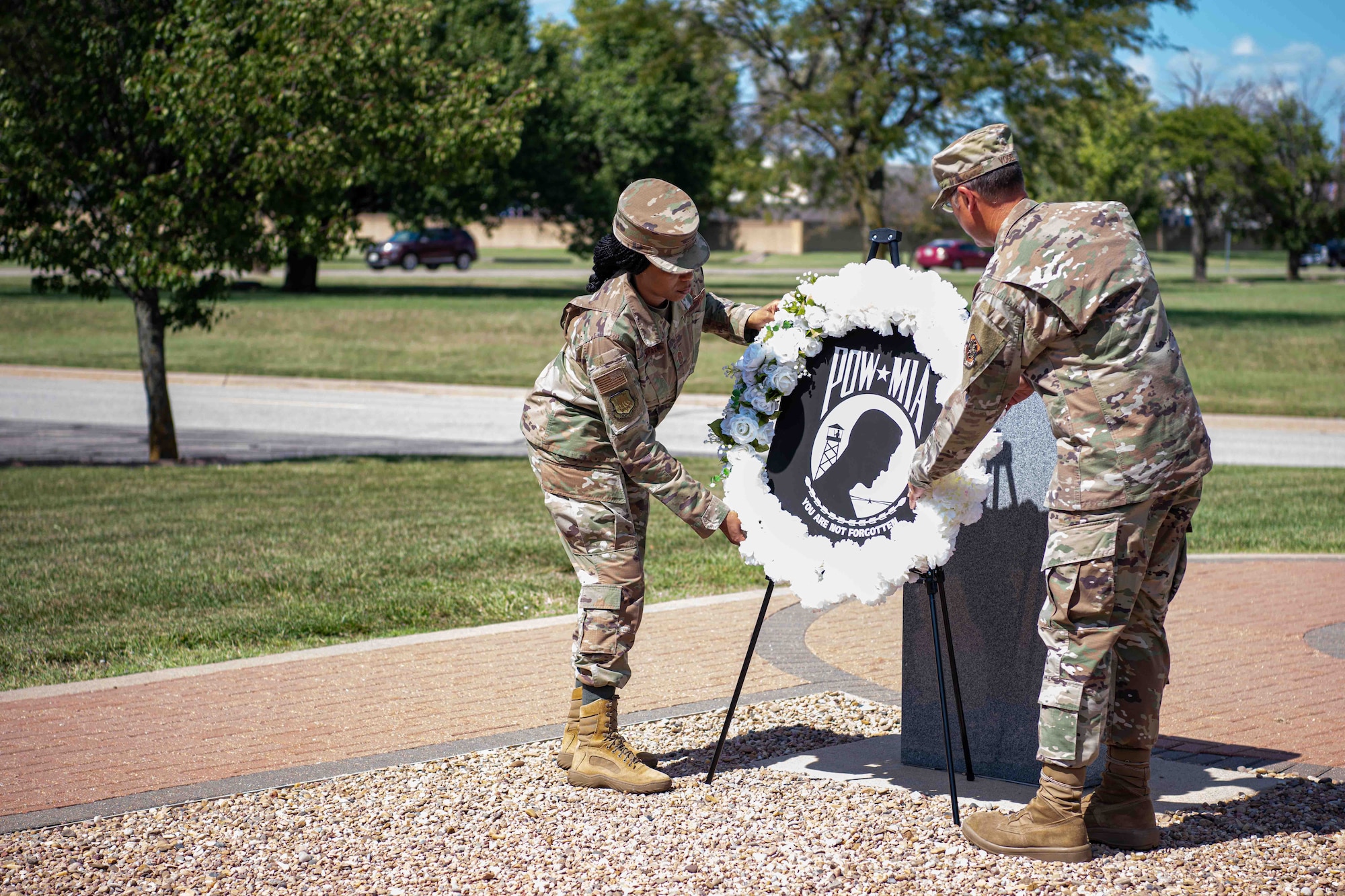 Col. Nate Vogel, 22nd Air Refueling Wing commander, and Chief Master Sgt. Melissa Royster, 22nd ARW command chief, lay a Prisoner of War/Missing in Action wreath during the POW/MIA wreath laying ceremony Sept. 16, 2021, at McConnell Air Force Base, Kansas. McConnell AFB hosts the ceremony to honor the United States’ Prisoners of War and those who are still Missing in Action. (U.S. Air Force photo by Senior Airman Marc A. Garcia)