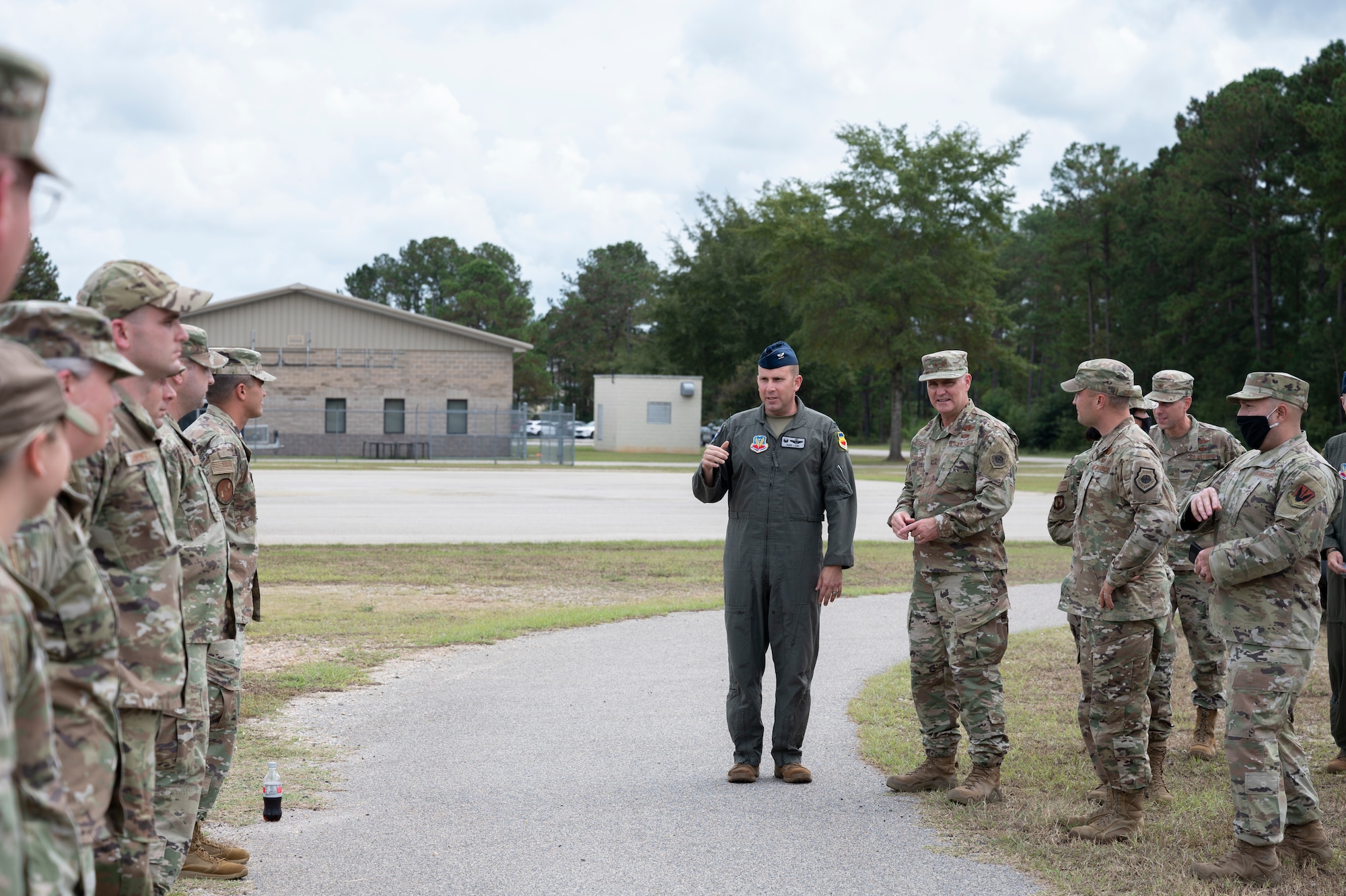 A photo of Airmen standing in a line greeting a visiting group.