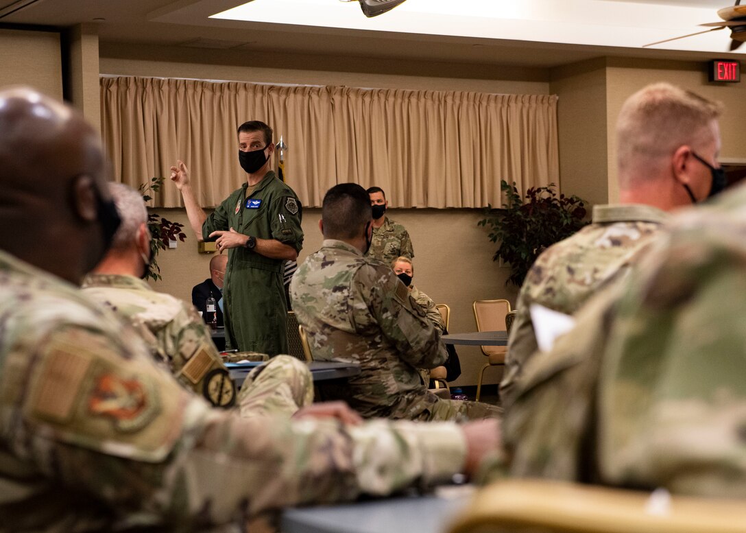 A commander speaks to a crowd of Airmen