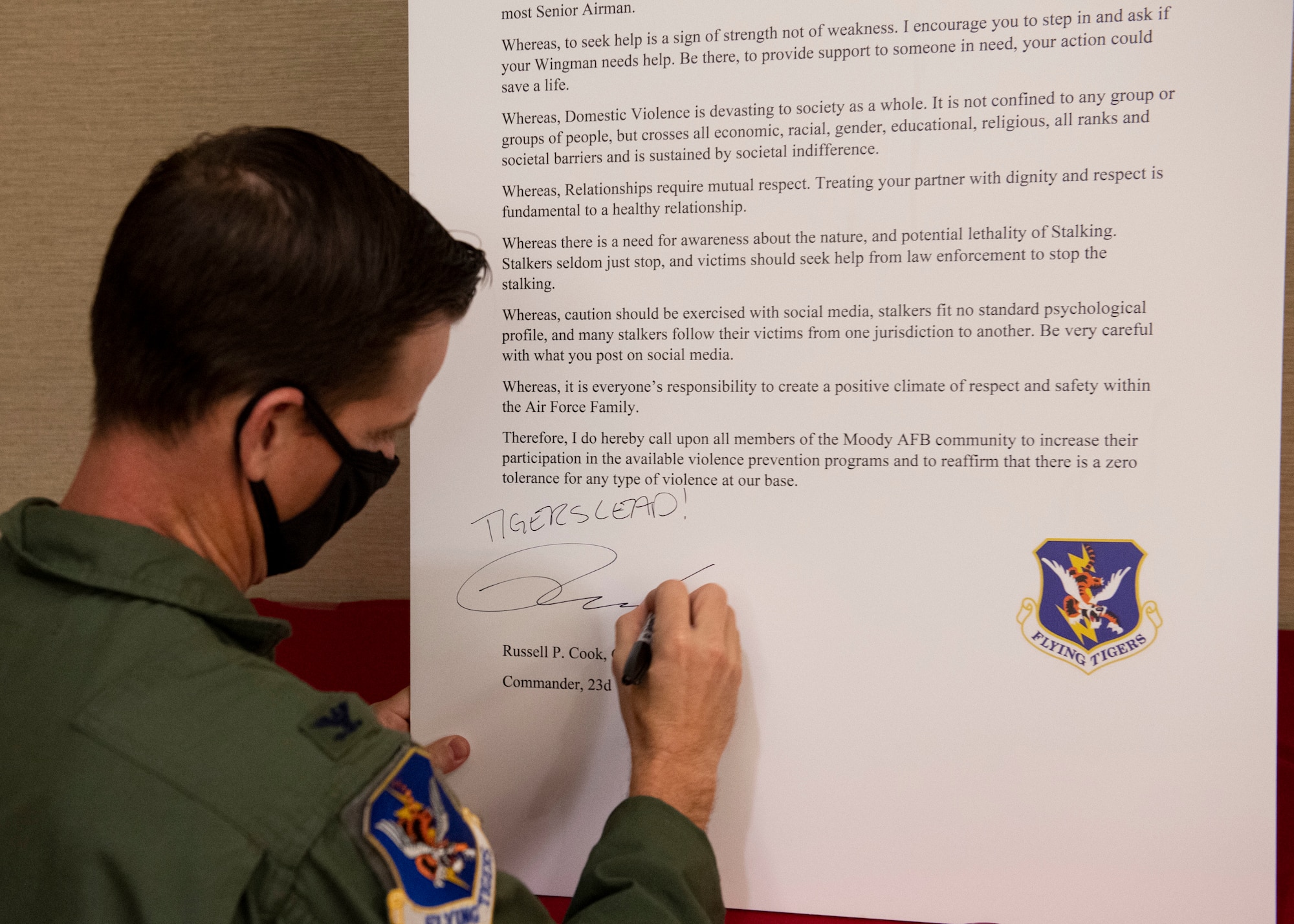 A commander signs a proclamation