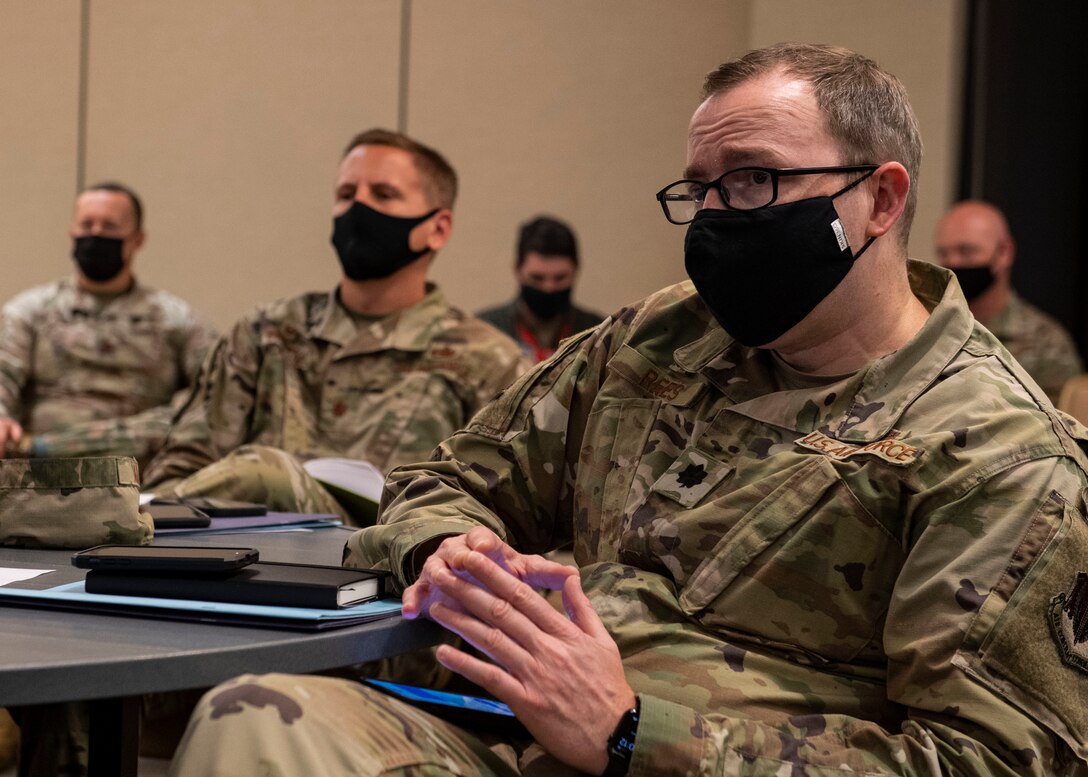 A commander listens to a briefing