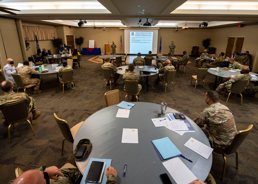 A group of Airmen sit at tables