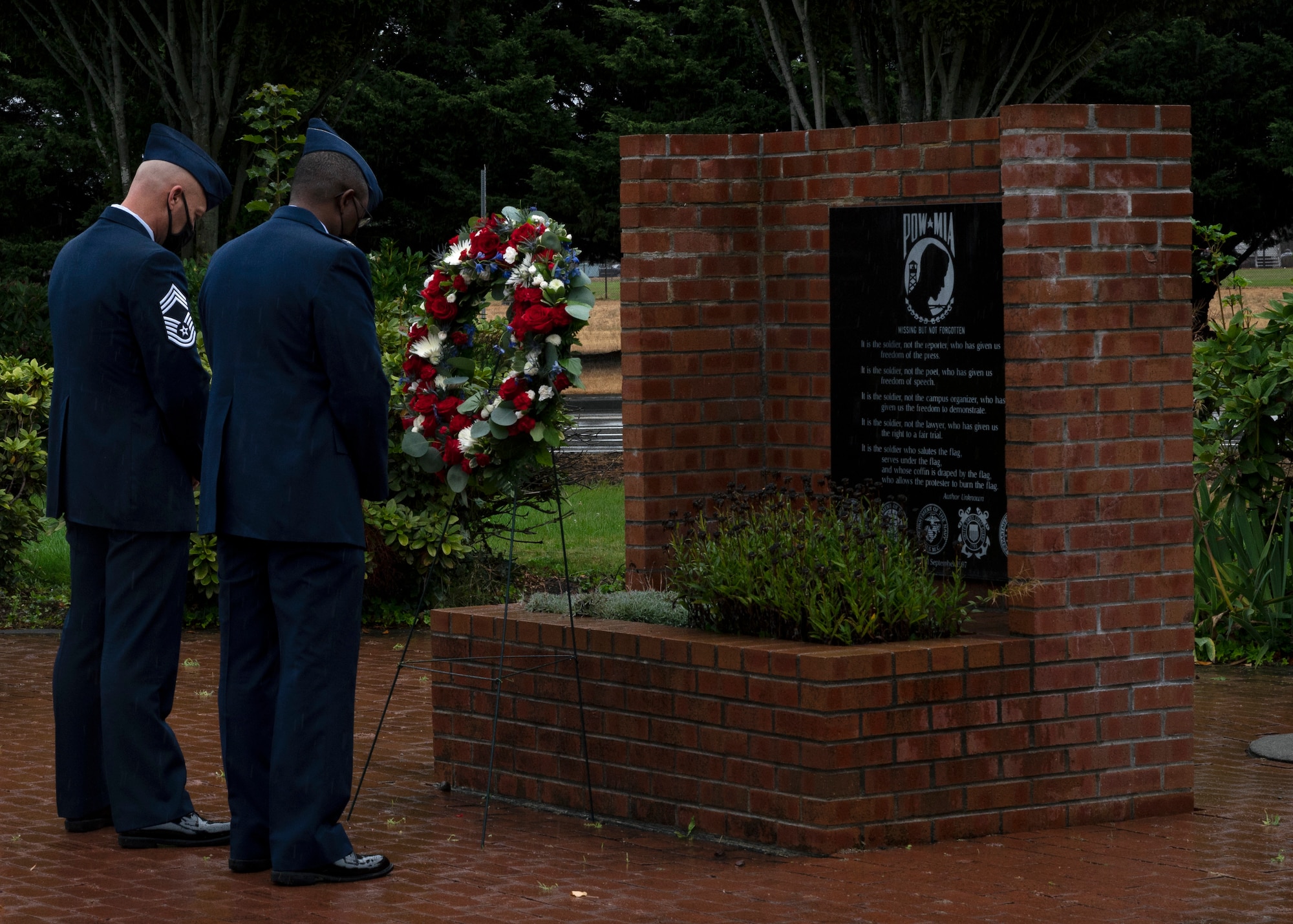 (From left) U.S. Air Force Chief Master Sgt. Christopher Clark, 627th Air Base Group superintendent, and Col. Christopher Hall, 627th ABG commander, observe a moment of silence after placing a wreath at the POW/MIA Memorial at Joint Base Lewis-McChord, Washington, Sept. 17, 2021. Team McChord Airmen gathered at the McChord War Memorial for the wreath ceremony to pay their respects to the more than 81,000 American heroes who were, and may still be, missing in action and those who were prisoners of war. (U.S. Air Force photo by Senior Airman Zoe Thacker)