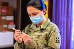 Sgt. Morgan Evans, a combat medic specialist assigned to 2nd Stryker Brigade Stryker Team, 4th Infantry Division, prepares a dose of the Pfizer-BioNTech COVID-19 vaccine at the COVID-19 vaccination site located in the William “Bill” Reed Special Events Center at Fort Carson, Colorado, on Sept. 1, 2021. The vaccination site provides initial doses of the Pfizer-BioNTech COVID-19 vaccine to Soldiers and second doses of the Moderna COVID-19 vaccine for those completing their series. (Jeanine Mezei)
