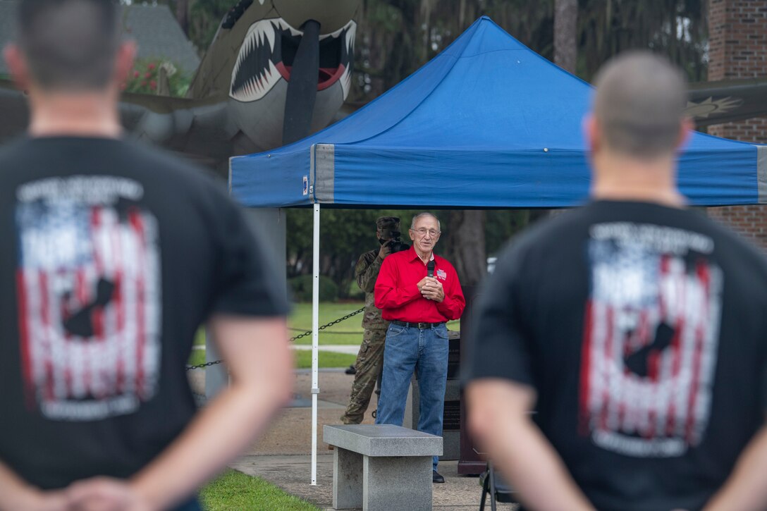 Man speaks to crowd.
