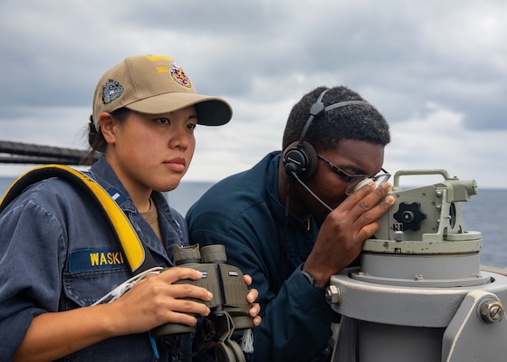 210917-N-YS413-5028 TAIWAN STRAIT (Sept. 17, 2021) Lt. j.g Chunchun Waskin, from Princeton, N.J., and Seaman Samuel Figueroa Lopez, from Hazelton, Pa., scan the sea for any surface contacts aboard Arleigh-burke class guided missile-destroyer USS Barry (DDG 52) as it transits the Taiwan Strait during a routine transit, Sept. 17. Barry is forward-deployed to the 7th Fleet area of operations in support of a free and open Indo-Pacific. (U.S. Navy photo by Mass Communication Specialist 3rd Class Justin Stack)"