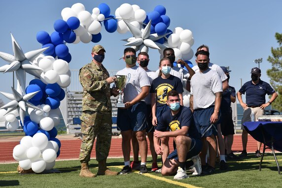 U.S. Air Force Col. Matthew Reilman, 17th Training Wing commander, presents the 17th Communications Squadron with the winning trophy for Wing Sports Day on Goodfellow Air Force Base, Sept. 17, 2021. Over 150 members participated in the wing-wide sports event. (U.S. Air Force photo by Senior Airman Jermaine Ayers)