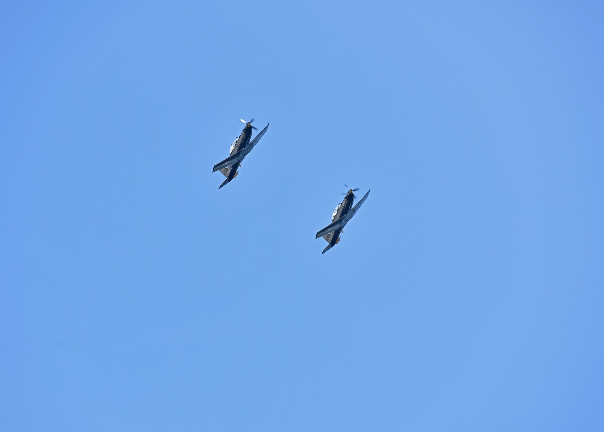 Two T-6 Texans II’s fly over during Wing Sports Day on Goodfellow Air Force Base, Texas, Sept. 17, 2021. The 85th Training Wing and the 47th Operations Support Squadron from Laughlin Air Force Base, Texas supported the flyover. (U.S. Air Force photo by Senior Airman Ashley Thrash)