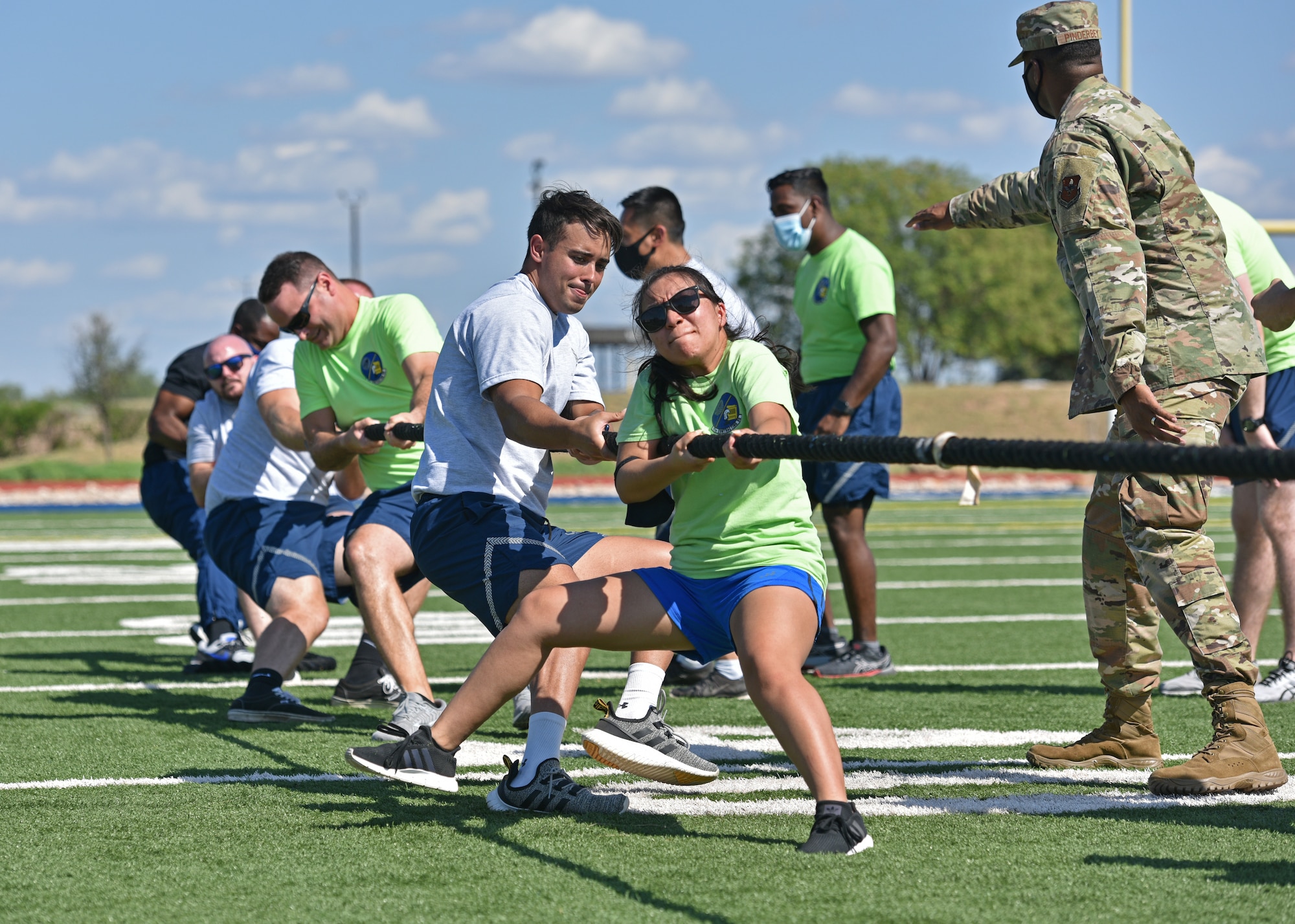 Members from the 17th Contracting Squadron participate in a tug-of-war competition during Wing Sports Day on Goodfellow Air Force Base, Texas, Sept. 17, 2021. Teams worked together to pull the marker on the rope across the line as quickly as possible. (U.S. Air Force photo by Senior Airman Ashley Thrash)