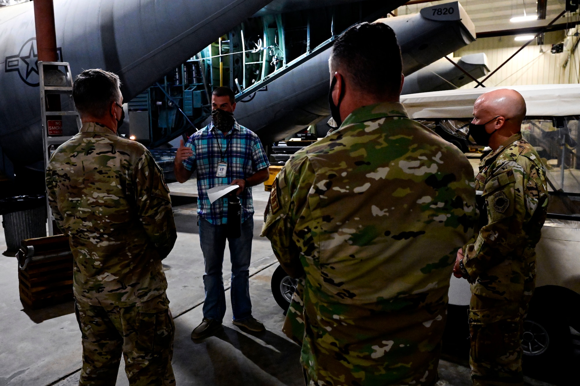 A group of people listen to a briefing