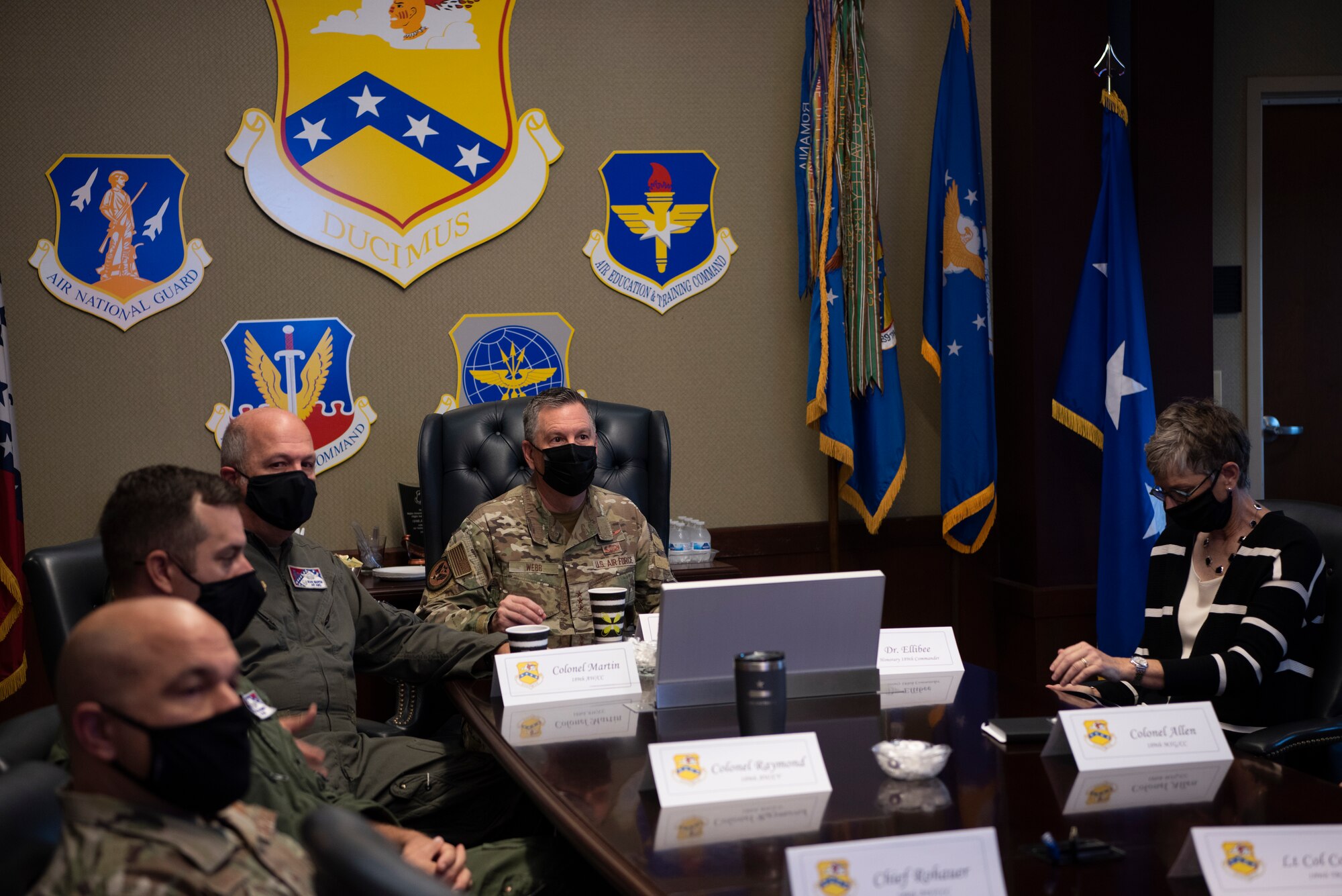 A group of people listen to a briefing