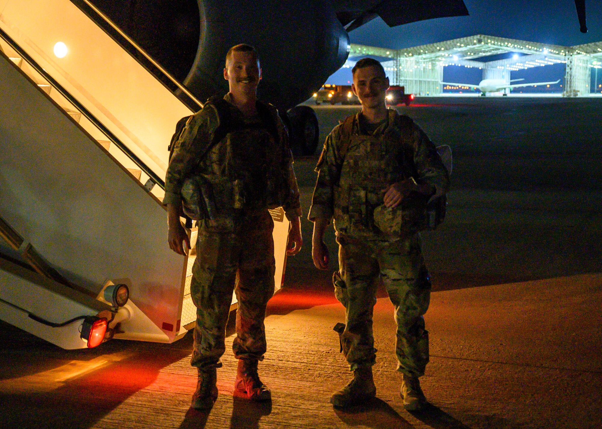 U.S. Air Force Staff Sgt. Harold S. Balcom III (left) and U.S. Staff Sgt. Jacob T. Crabtree (right), air traffic control liaisons assigned to the 378th Expeditionary Operations Support Squadron, pose for a photo on the flightline at Prince Sultan Air Base, Kingdom of Saudi Arabia, just after returning from a forward deployment to Afghanistan, Aug. 31, 2021. The two Airmen joined coalition forces in providing air traffic control support for non-combatant evacuation operations at Hamid Karzai International Airport, Kabul, controlling more than 1,000 aircraft over a 12-day period and contributing to the evacuation of over 120,000 personnel. (U.S. Air Force photo by Senior Airman Samuel Earick).